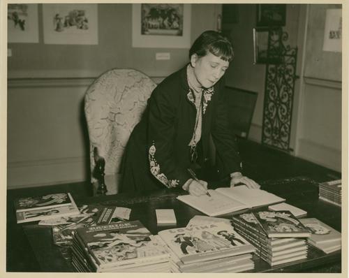 Milhous signing her books